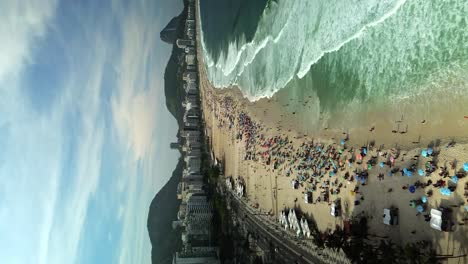 Crowded-Copacabana-Beach-on-Summer-Day-in-Rio-de-Janeiro,-Brazil,-Vertical-Aerial