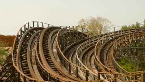 Stampida-Tomahawk-roller-coaster-wooden-tracks-in-Salou,-Spain-on-sunny-day