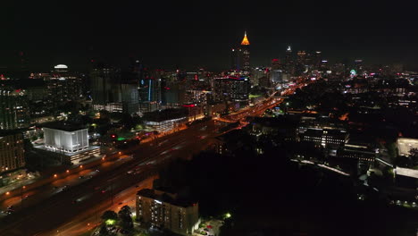 Aerial-panoramic-night-view-of-metropolis-with-busy-multilane-thoroughfare-and-high-rise-office-downtown-buildings