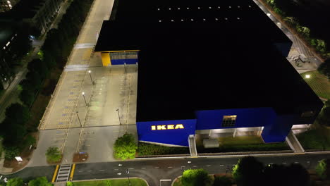 Aerial-descending-shot-of-modern-Ikea-store-at-night