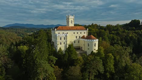 Trakoscan-Castle-Surrounded-By-Forested-Hills-In-Croatia---aerial-shot