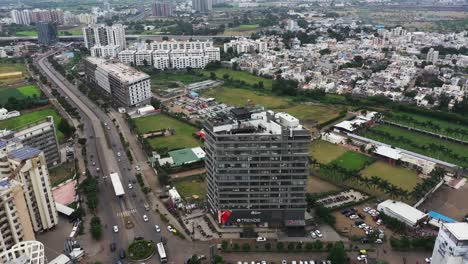 A-commercial-building-in-the-middle-of-Rajkot-city-is-surrounded-by-a-rear-drone-camera