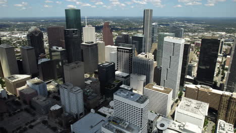 Aerial-view-of-cloud-shadows-moving-over-the-skyline-of-Houston,-TX,-USA
