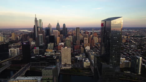 Aerial-tracking-shot-of-the-Philadelphia-skyline,-sunny-fall-evening-in-USA