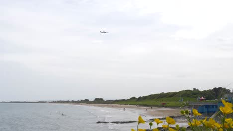 Airplane-Flying-Above-Portmarnock-Velvet-Strand-Beach-In-Dublin,-Ireland
