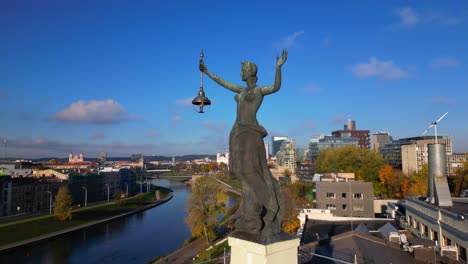 Sculpture-of-woman-holding-a-light-next-to-Neris-river-in-Lithuanian-capital-Vilnius