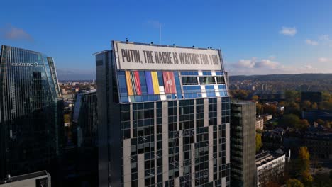 Putin-The-Hague-is-Waiting-for-you-protest-sign-in-Vilnius-fixed-aerial-shot