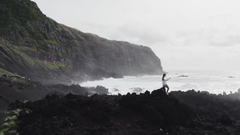 Girl-tourist-at-Ponta-da-Ferraria,-São-Miguel-Azores,-overlooking-ocean-and-cliffs