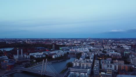 Evening-blue-light-aerial-over-Baltic-city-Helsinki,-Crusell-Bridge