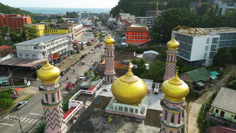 Aerial-flying-backwards-over-mosque-in-Ao-nang,-Thailand