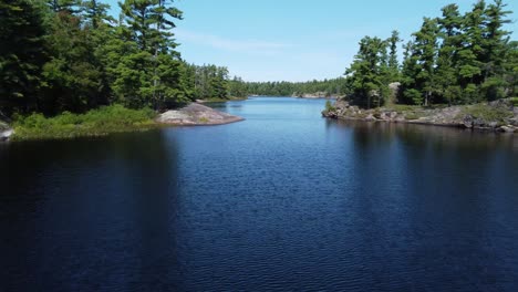 Fly-over:-Canada's-Grundy-Lake,-serene-water-with-forested-shores