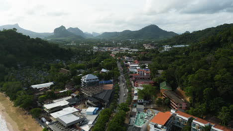 Thailand-town-and-majestic-forestry-mountains,-aerial-drone-view