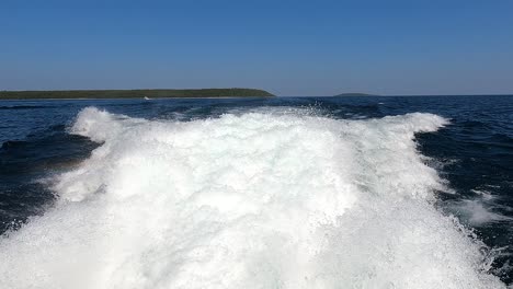 Churning-boat-wake-with-distant-Huron-Lake-islands