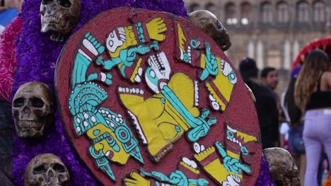 Close-up-over-a-mexican-costume-of-a-traditional-mythological-zodiac-calendar-surrounded-by-human-skulls