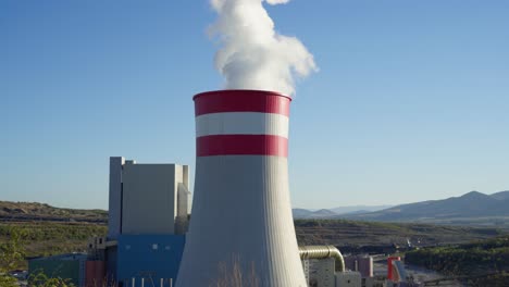 Coal-fired-power-station-plant-Smoke-Steam-Chimney-rural-sunny-clear-sky-day