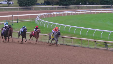 Toma-Panorámica-Siguiendo-A-Los-Jinetes-A-Caballo-En-El-Derby-De-Carreras-De-Caballos-De-Keenland-En-Lexington,-Kentucky