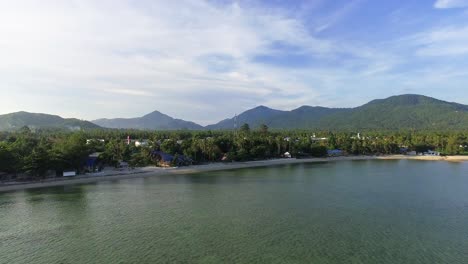 An-aerial-pan-shot-of-Bann-Tai-beach-located-in-Koh-Pangan,-Surat-Thani-province-in-the-south-of-Thailand