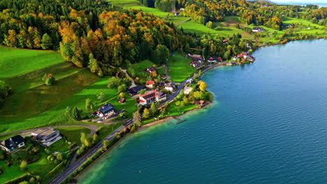 Aerial-view-overlooking-a-town-on-the-coast-of-lake-Attersee,-fall-in-Austria