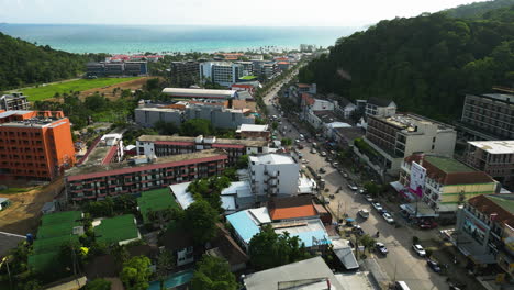 Aerial-flying-over-Ao-Nang-on-sunny-day,-Andaman-Sea-in-background