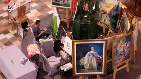 An-overhead-shot-of-a-group-of-artists-having-an-exhibition-at-Terminal-21-Pattaya-while-doing-some-quick-sketches-and-painting-on-the-side