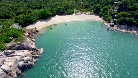 View-from-drone-of-empty-Haad-Than-Sadet-beach-in-Thailand,-Pan-Up