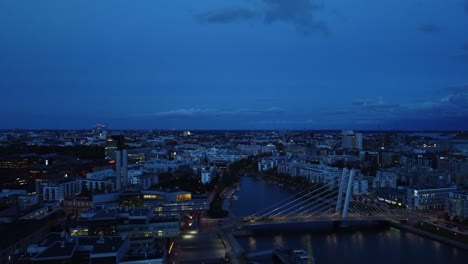 Rich-blue-hour-aerial-view-of-Helsinki-traffic-on-Crusell-Bridge,-FIN
