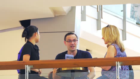 Two-ladies-and-a-man-are-having-a-conversation-over-coffee-inside-a-mall-in-Bangkok,-Thailand