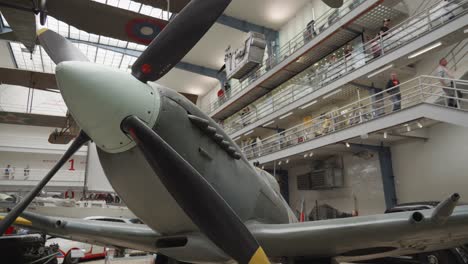 Close-up-of-Spitfire-aircraft-at-historical-planes-exhibition-in-National-Technical-Museum-in-Prague,-Czech-Republic,-tilt-down-shot