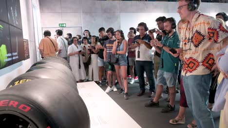Visitors-and-Formula-1-enthusiasts-look-at-Pirelli-F1-racing-tyres-displayed-during-the-world's-first-official-Formula-1-exhibition-at-IFEMA-Madrid,-Spain