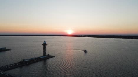 Lake-Erie-at-Sunset-in-Erie-Pennsylvania-with-Bicentennial-Tower-Ascending-Revealing-Horizon