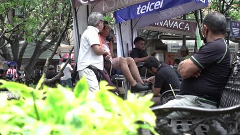 Hand-held-shot-of-shoe-cleaners-cleaning-customers'-shoes-in-Mexico-City