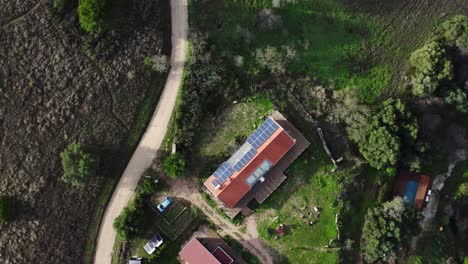 Drone-shot-of-farm-building-with-solar-panels-on-the-roof