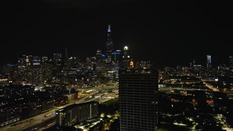 Drone-shot-revealing-the-illuminated-Jane-Byrne-Interchange,-in-Chicago,-USA