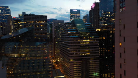 Aerial-view-ascending-in-middle-of-buildings-in-River-North,-dusk-in-downtown-Chicago,-USA