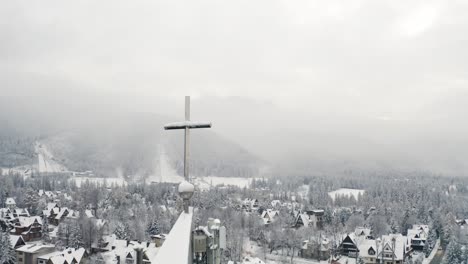 Aerial-Winter-close-up-of-the-Holy-Cross-on-top-of-Tatra-Parish-Church-Zakopane