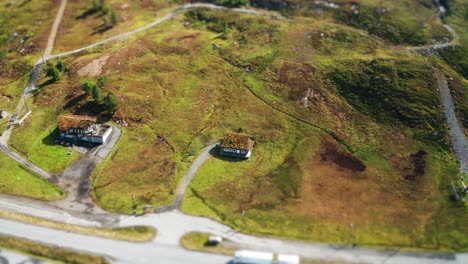 Miniature-northern-huts-with-grass-roofs-aerial-shot