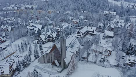 Drone-Aerial-of-the-On-Tytusa-Chalubinskiego-Tatra-Parish-Church-covered-in-winter-snow