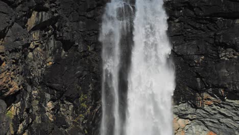 A-waterfall-on-the-rocky-cliffs-of-the-Kjenndalsbreen-glacier