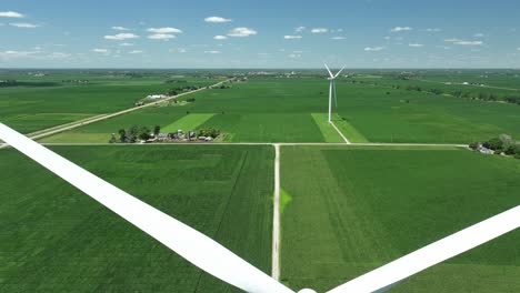 Static-Wind-Turbines-On-Lush-Agricultural-Fields-In-Slater,-Iowa,-USA