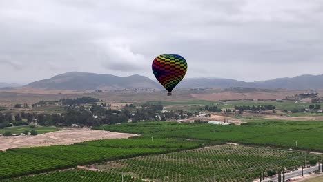 Aerial-of-hot-air-balloon-over-Temecula-vineyard-wine-country-on-a-cloudy-morning-adventure