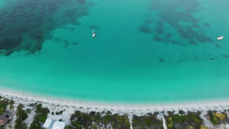 Beautiful-Aerial-Shot-of-Aqua-Water,-Bahamas-Beach,-and-Sailboats-Anchored-Off-the-Coast
