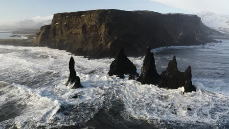 Aerial-view-tilting-away-from-the-Reynisdrangar-rocks-on-the-coast-of-sunny-Iceland