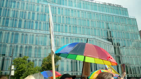 Marsch-Der-Freiheit-Zur-Verteidigung-Der-Demokratie-In-Warschau-Mit-Menschenbannern-Und-Regenbogenfarbenen-Regenschirmen-Am-Bürogebäude-Vorbei