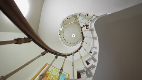 Rotating-Low-angle-shot-of-spiral-staircase-in-old-vintage-historical-building