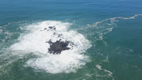 Aerial-view-of-Big-ocean-waves-crashing-on-coral-islands---Orbit-drone-shot