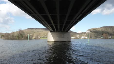 Perfect-symmetry-below-bridge-crossing-large-body-of-water,-midday