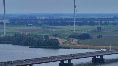 Traffic-On-The-Bridge-Over-The-Hollands-Diep-River-Near-The-Wind-Turbines-In-Moerdijk,-Netherlands