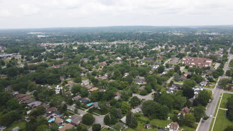 Aerial-panoramic-view-above-suburban-neighborhood-on-overcast-day,-space-for-text