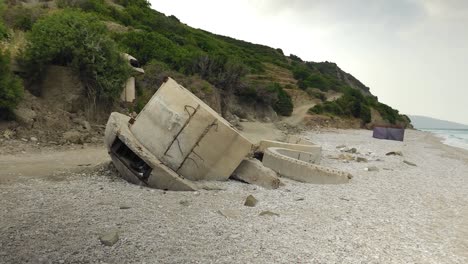 Bunkers-plunged-on-beach-remaining-from-communist-era-of-the-dictatorship-in-Albania,-historic-artefact-museum-of-depression