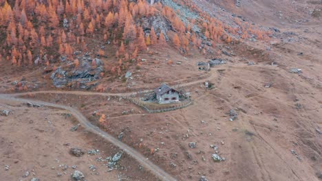 Remote-grey-stone-house-in-picturesque-autumn-colored-Italian-mountain-forest